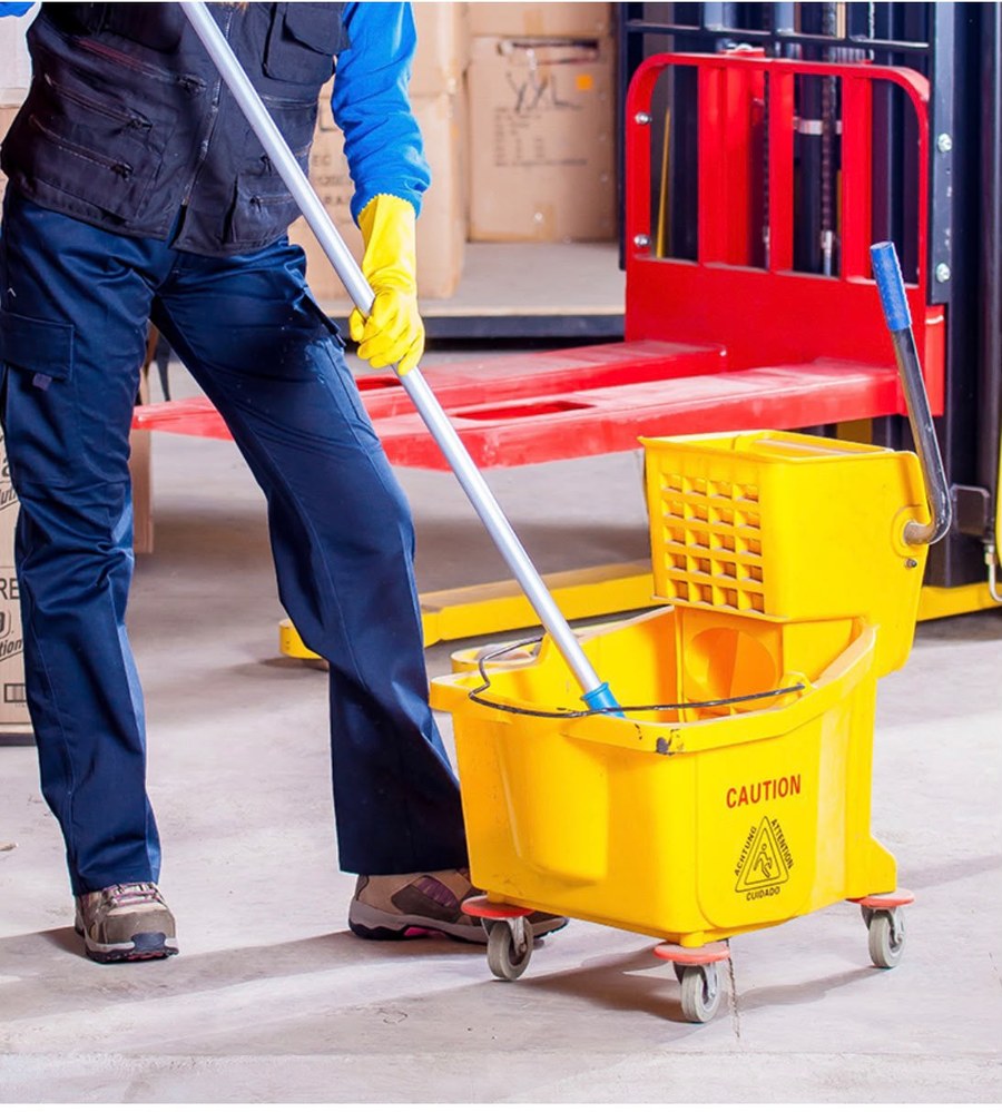 Clean Clean Commercial Cleaning technician mopping a commercial facility
